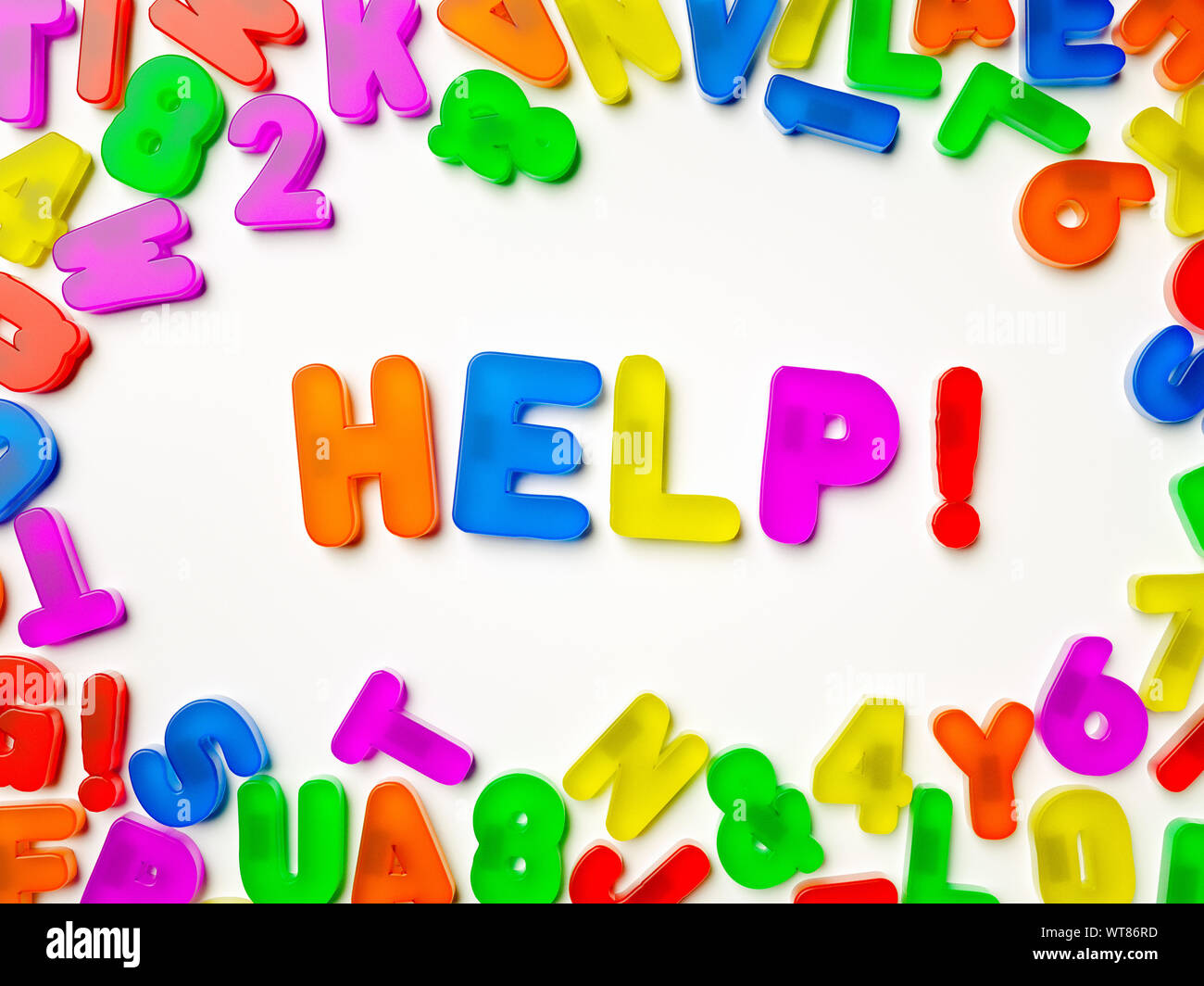 Help. Word. Plastic multi coloured fridge magnet alphabet spelling Help! Stock Photo