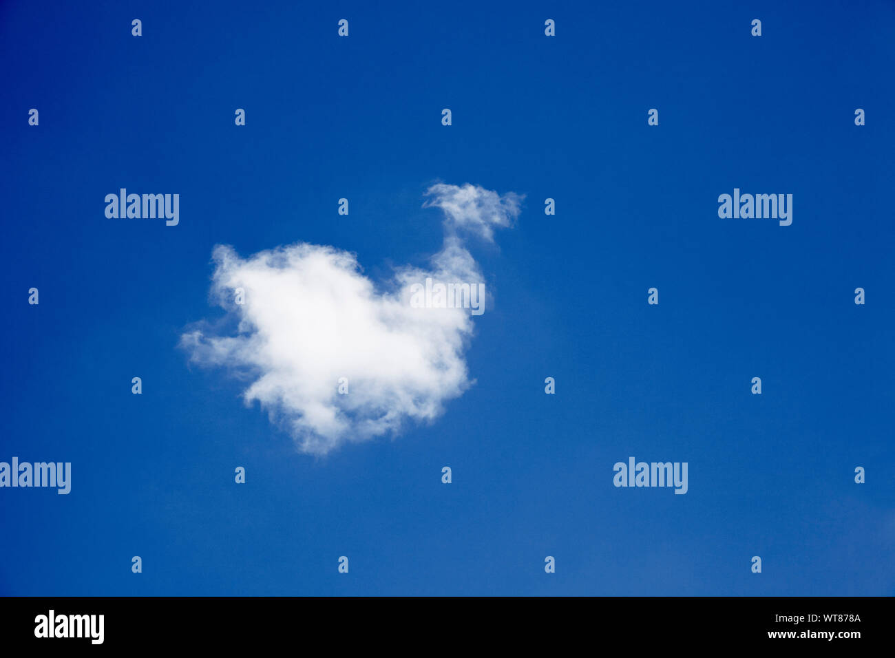 Blue sky and single solitary cloud Stock Photo