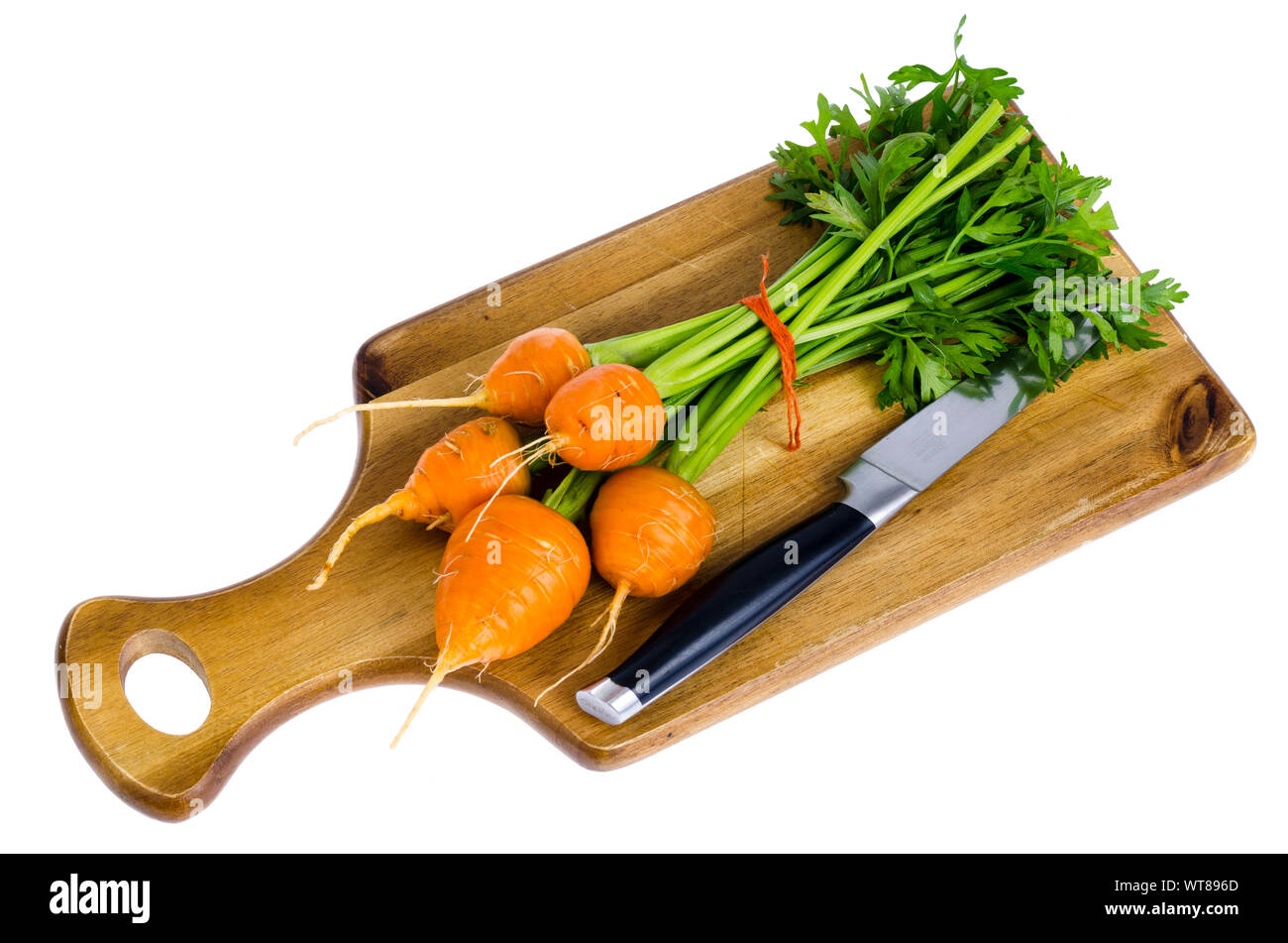 Bunch of small, round carrots (Parisian Heirloom Carrots) on wooden background. Studio Photo Stock Photo