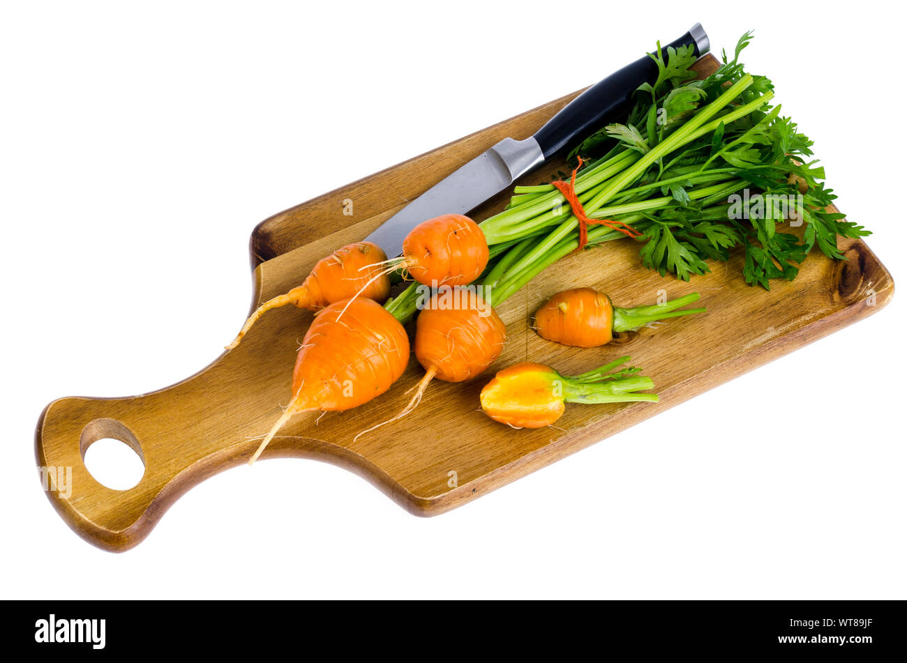 Bunch of small, round carrots (Parisian Heirloom Carrots) on wooden background. Studio Photo Stock Photo