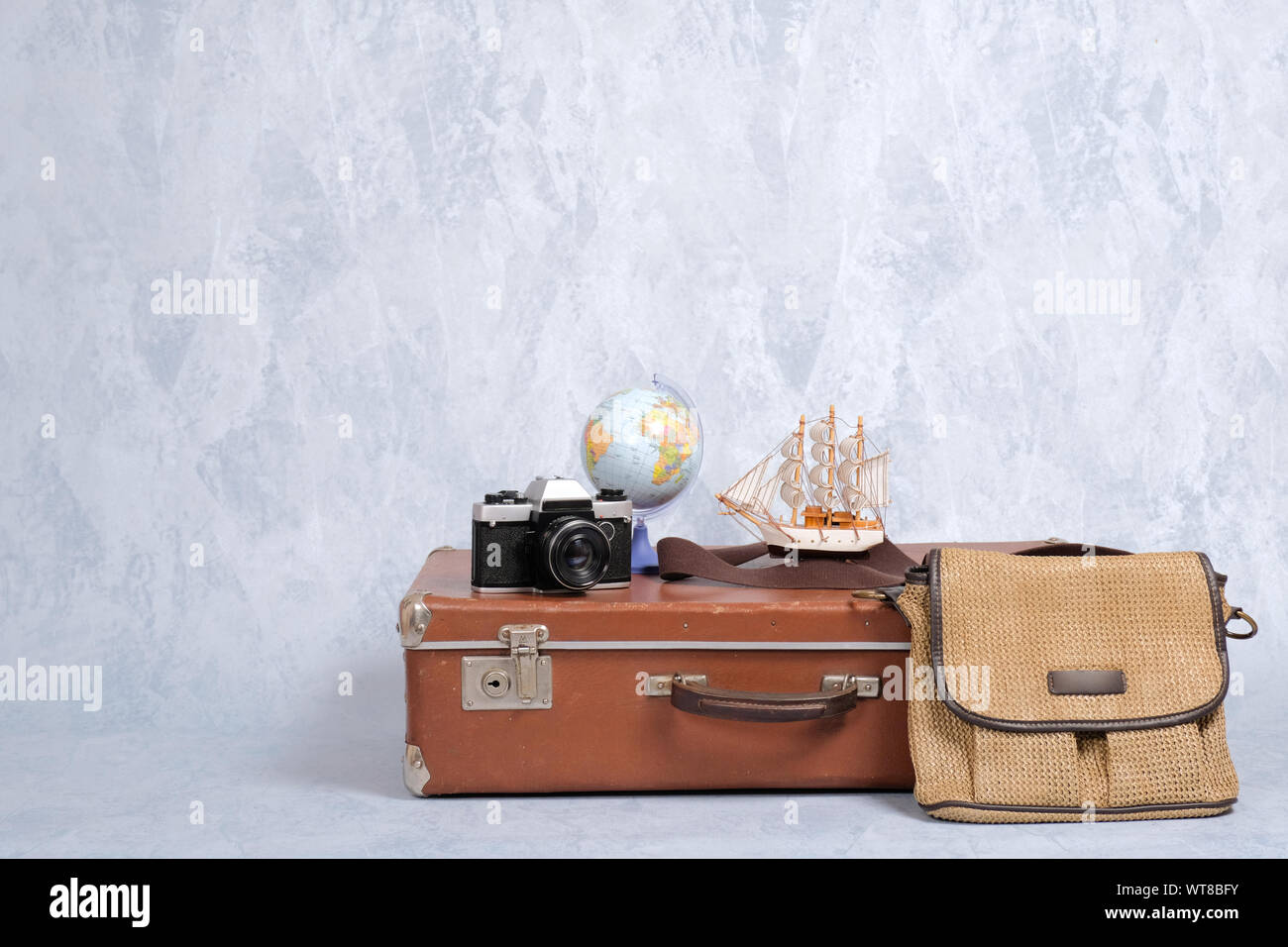 Shabby vintage suitcase with summer marine accessories on grey background. Travel or tourism, summer holiday, vacation concept, banner mockup with cop Stock Photo