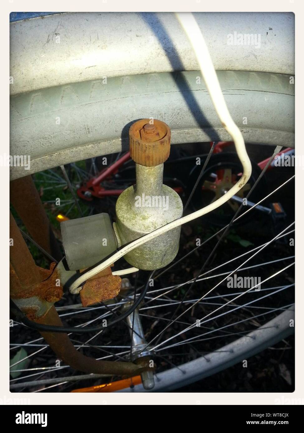 Close Up Of Rusty Dynamo On Bike's Wheel Stock Photo