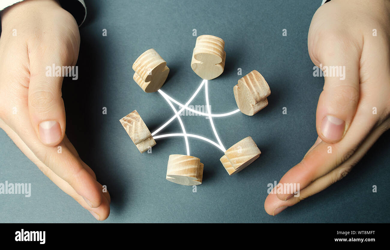 A man wraps his arms around a circle of employee figures. Collaboration