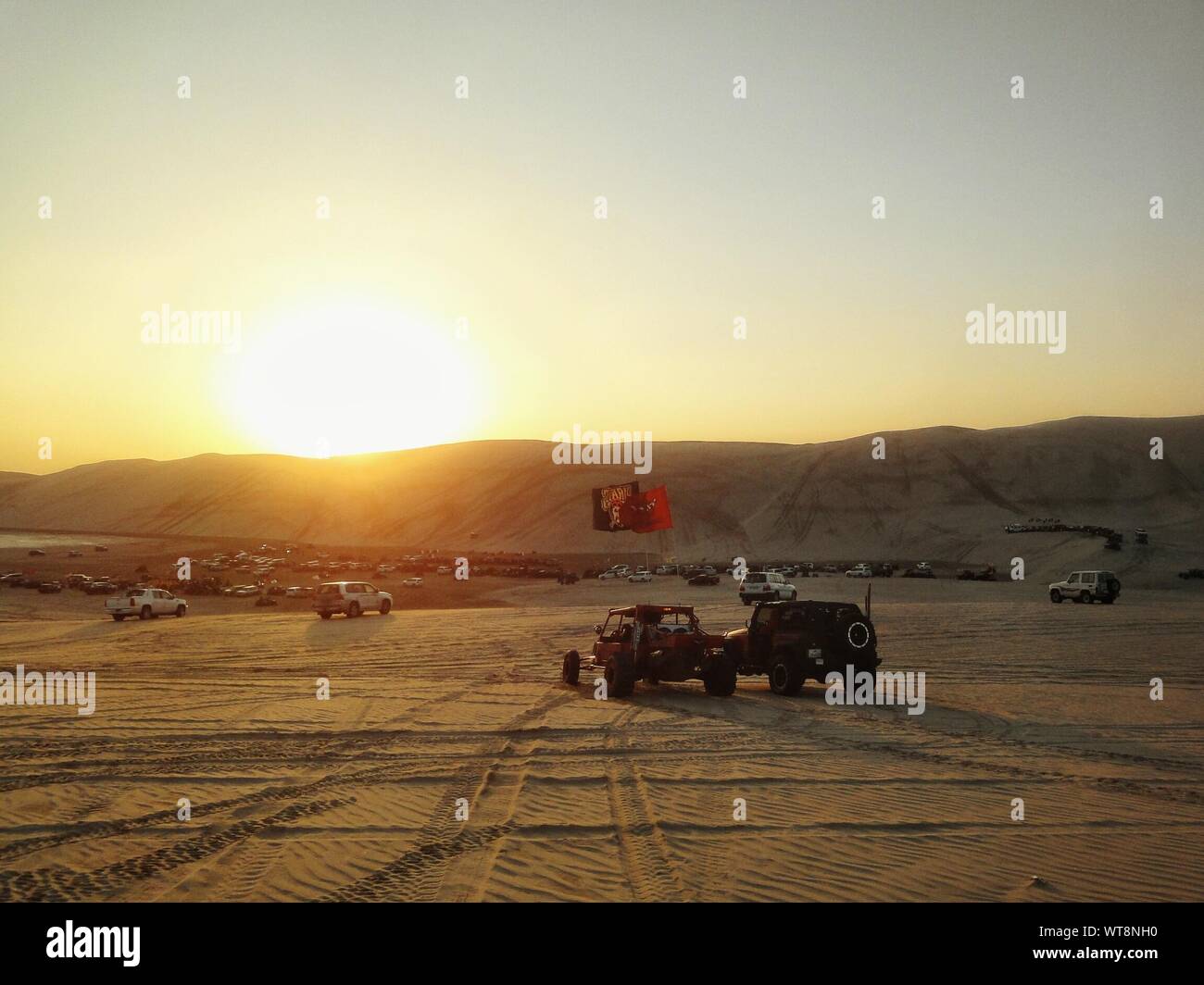 Sport Utility Vehicle On Desert At Sunset Stock Photo