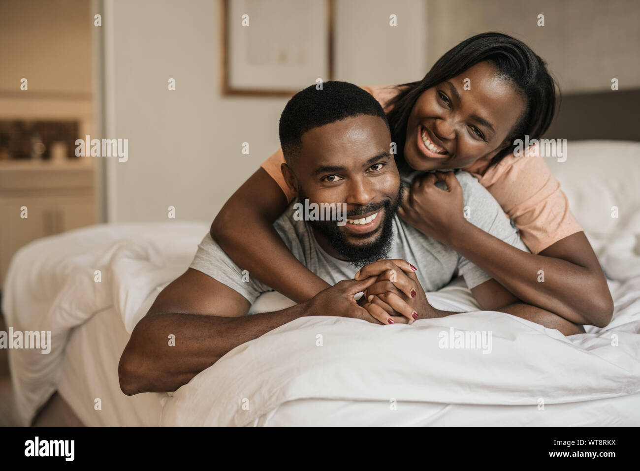 African american couple cuddling in bed hi-res stock photography and ...