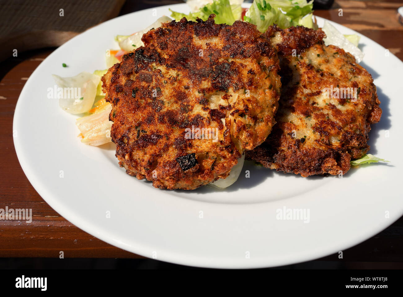 traditional tirolean flat bread dumplings kaspressknödel filled with mountain cheese served with green salad Tirol alm Stock Photo