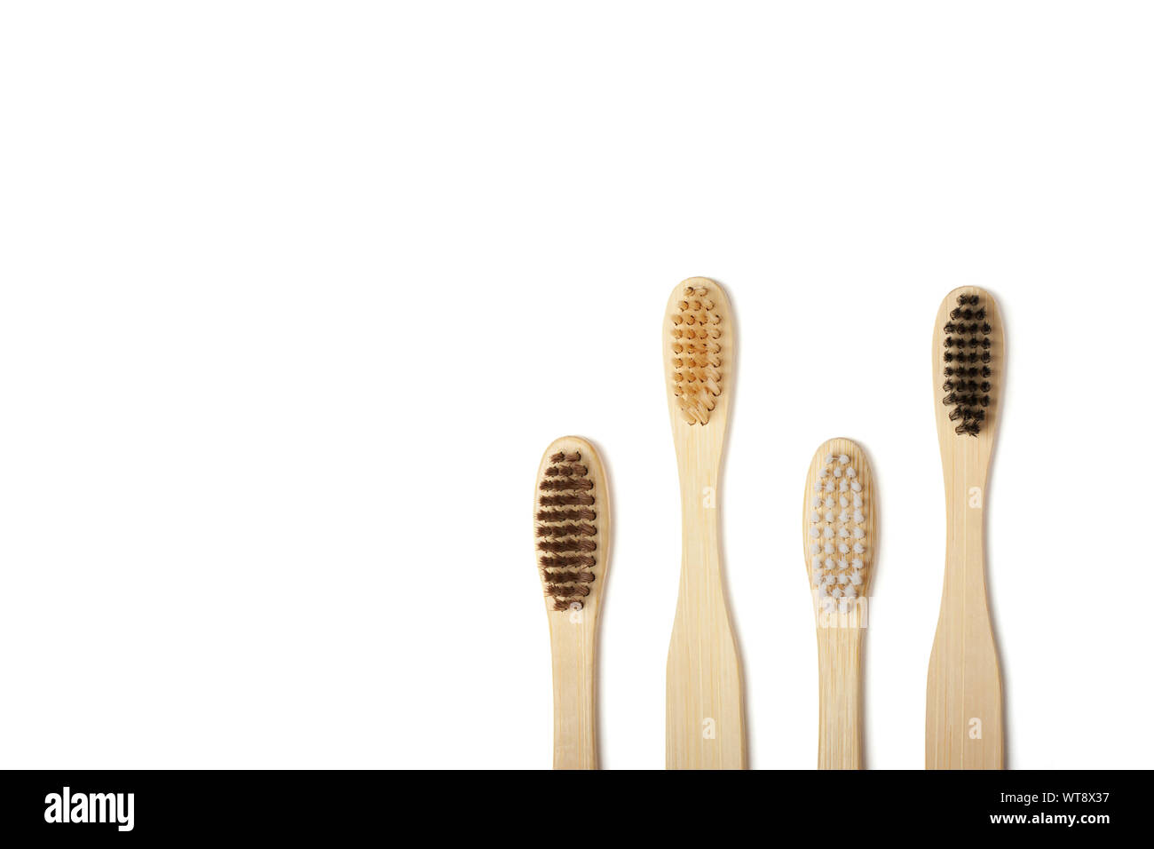 Four eco-friendly bamboo toothbrushes isolated on the white background ...
