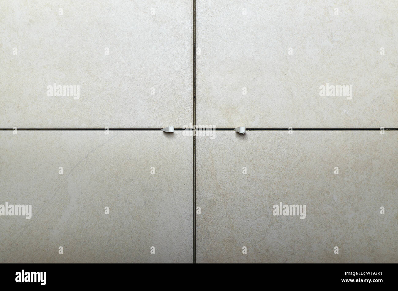 Tiles with plastic tile spacers on a wall during montage Stock