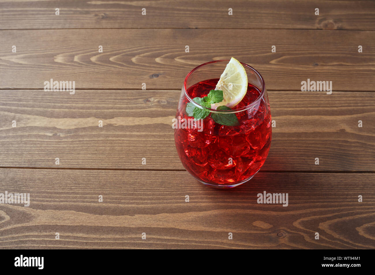 glass of cold tea red drink closeup isolated on table Stock Photo - Alamy