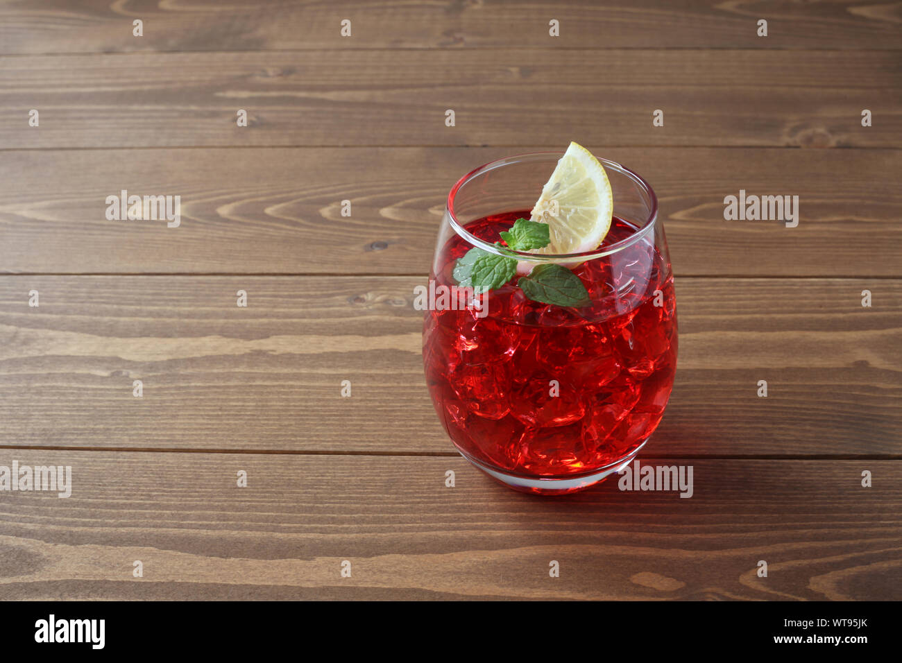 glass of cold tea red drink closeup isolated on table Stock Photo - Alamy