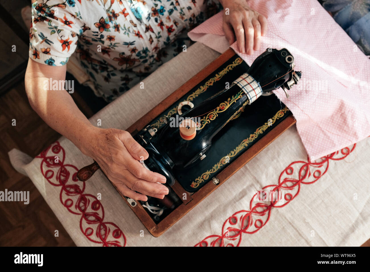 Using Traditional Sewing Machine Hands of grandmother use retro manual sewing machine Stock Photo - Alamy