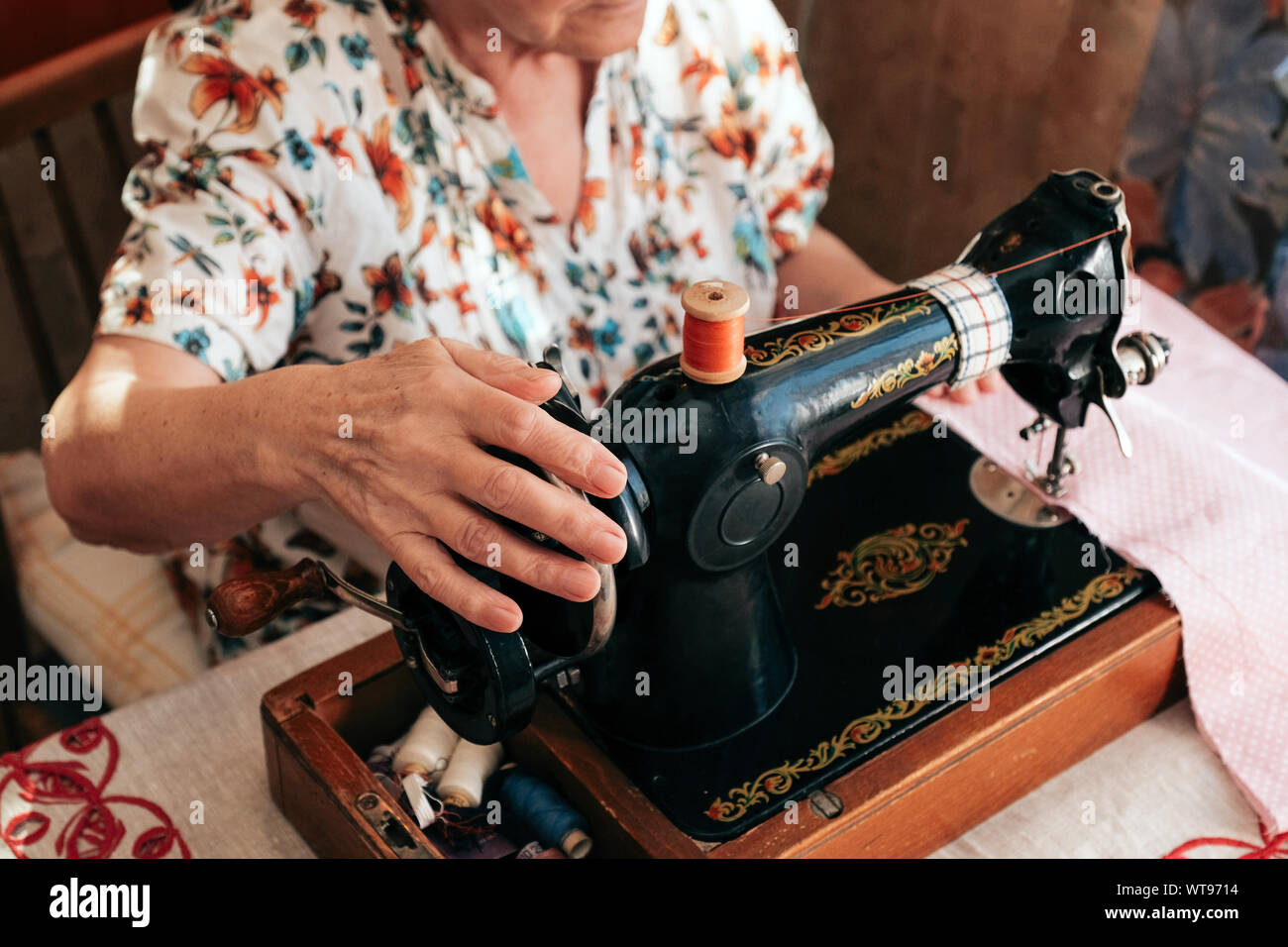 Using Traditional Sewing Machine Hands of grandmother use retro manual sewing machine Stock Photo - Alamy