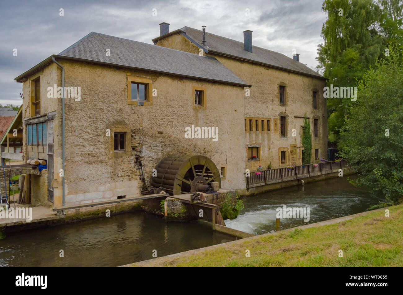 Old water mill on the tuna river running through the city of Virton eprovince du Luxembourg in Belgium Stock Photo