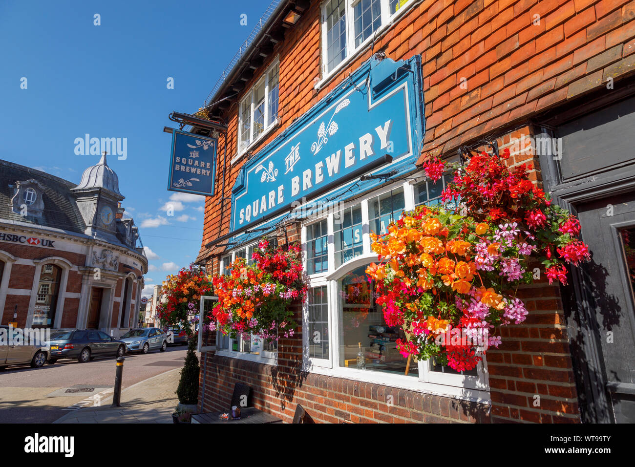 The Square Brewery decorated with pretty hanging baskets in the centre of the market town of Petersfield, Hampshire, southern England, UK Stock Photo
