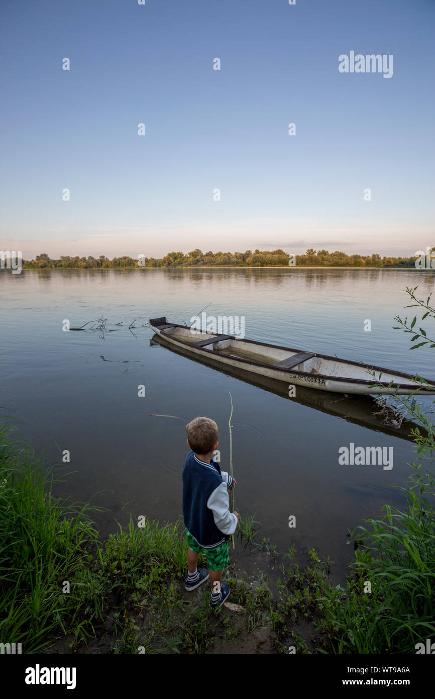 Boy fishing by the Vistula river, Poland Stock Photo