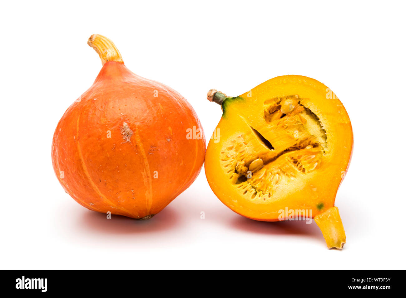 Whole and halved Red Kuri squashes isolated on white background Stock Photo
