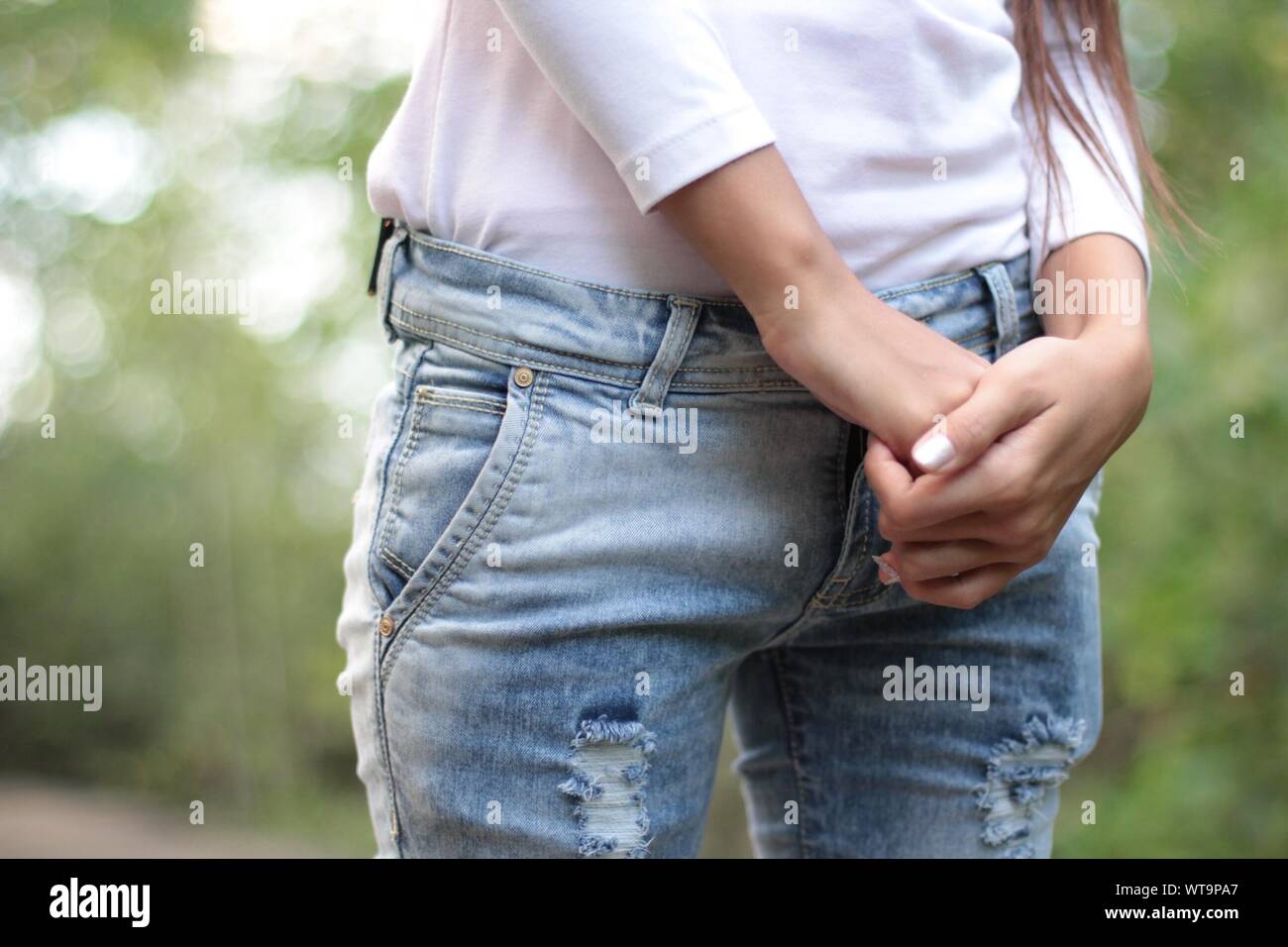 Midsection Of Woman With Hands Clasped Stock Photo
