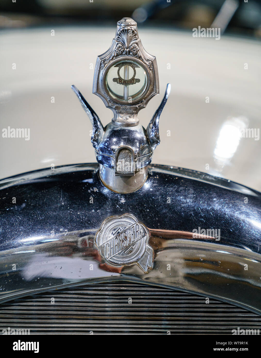 Close-up image of an antique car hood featuring Chrysler ornament Stock Photo