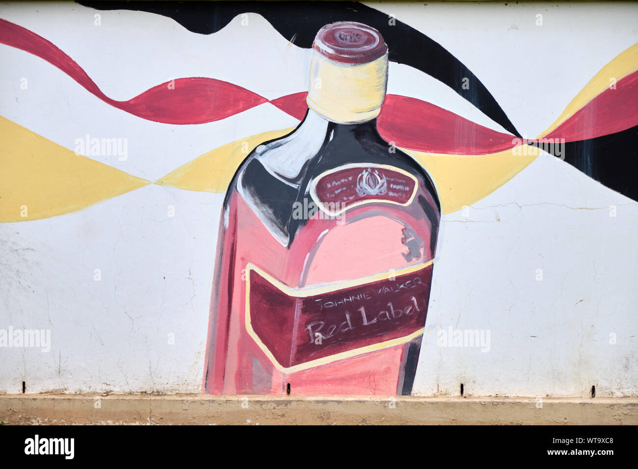 Advertising art on wall on side of a liquor store in South Africa. Bottle  of Johnnie Walker red label whisky Stock Photo - Alamy