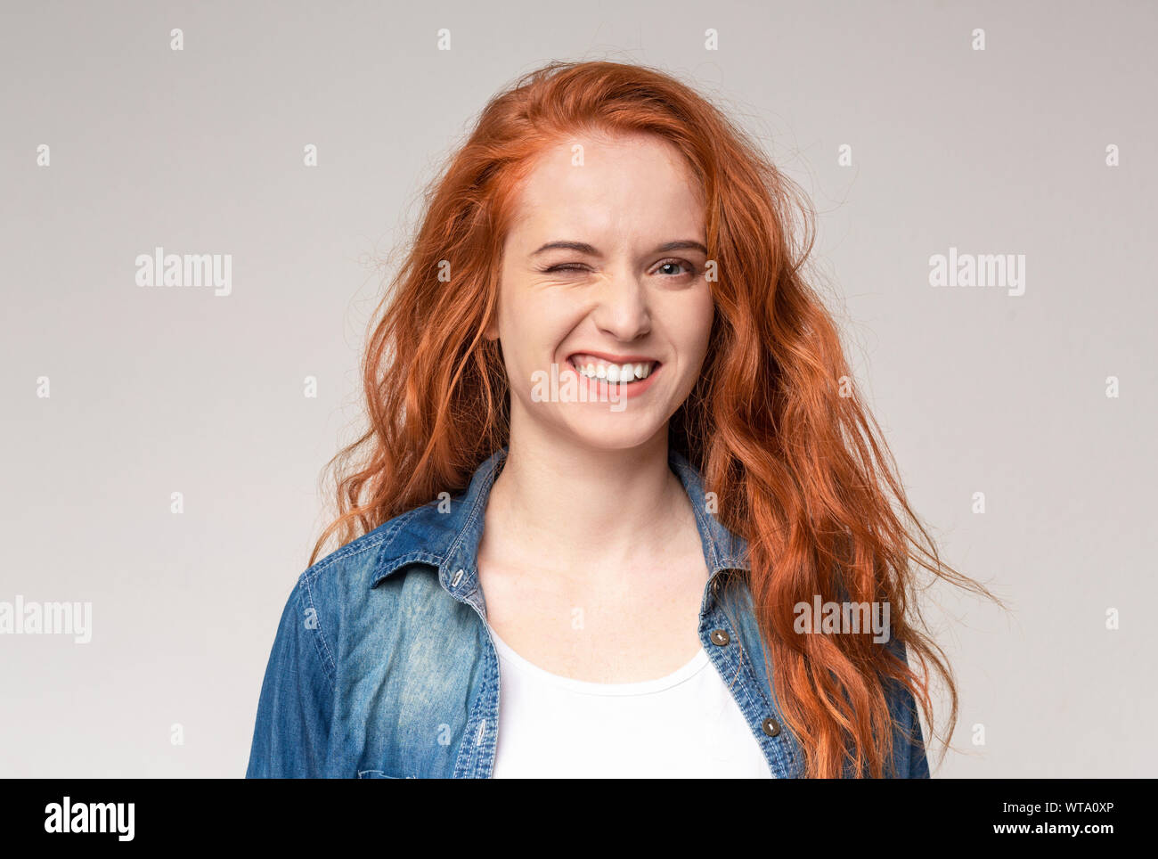 Ginger pube young girl Pretty young ginger girl winking over light background Stock Photo - Alamy