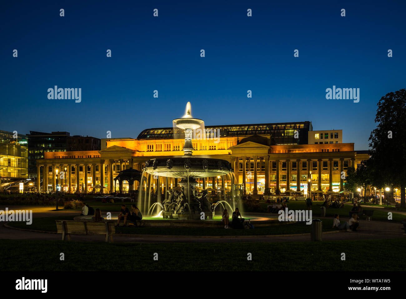 Stuttgart, Germany, August 25, 2019, Majestic illuminated lights of koenigsbau building at schlossplatz square downtown stuttgart behind fountain at n Stock Photo