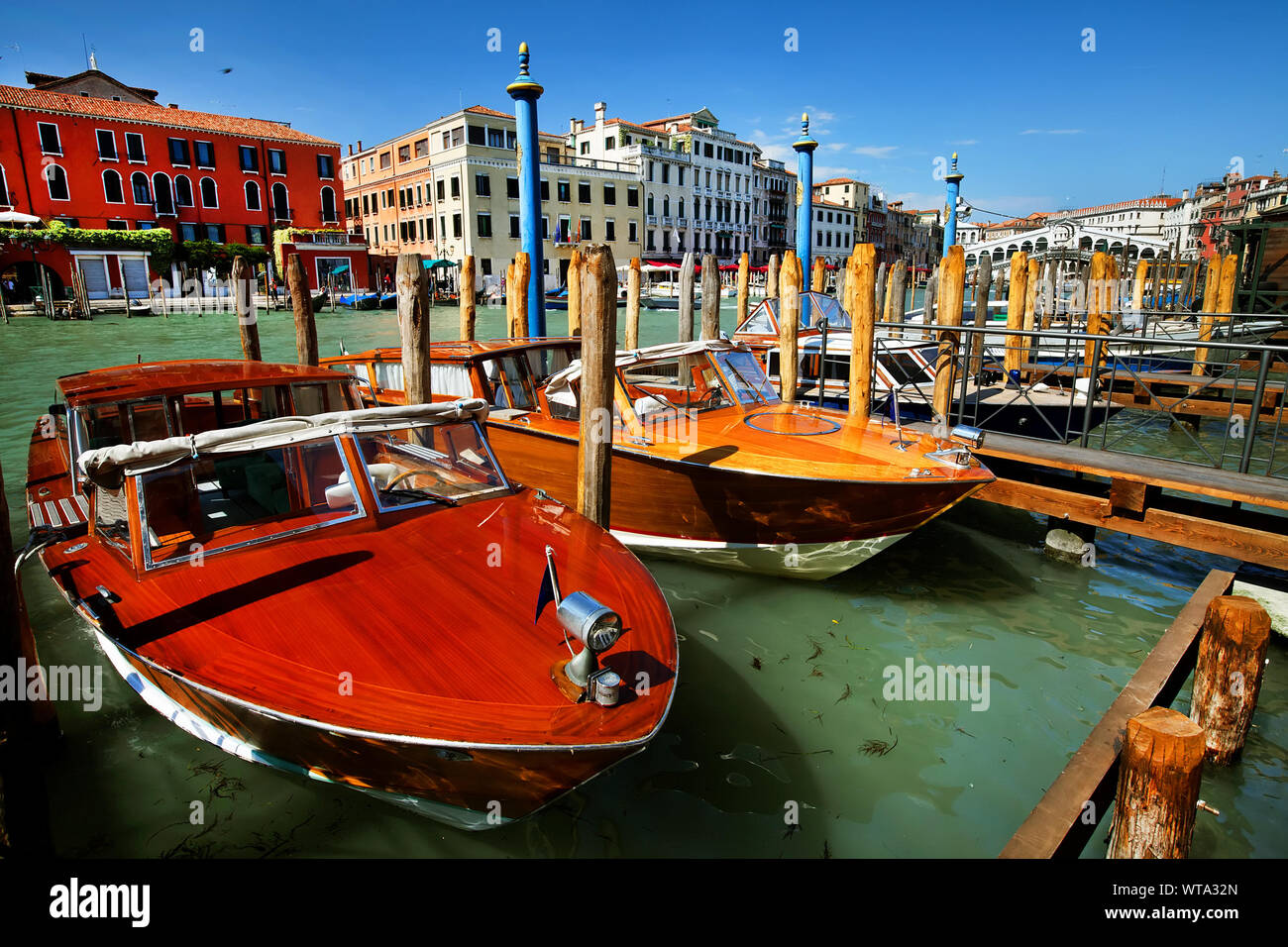 Motorboats Moored At Harbor On Sunny Day Stock Photo