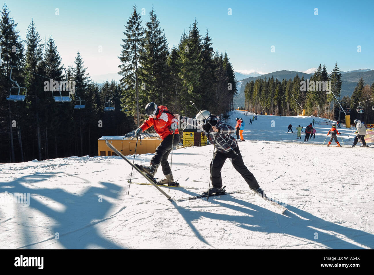 Bukovel, Ukraine. 2, 2017 Skiers fooling around on a slope in front of the camera. Bukovel ski resort Stock Photo