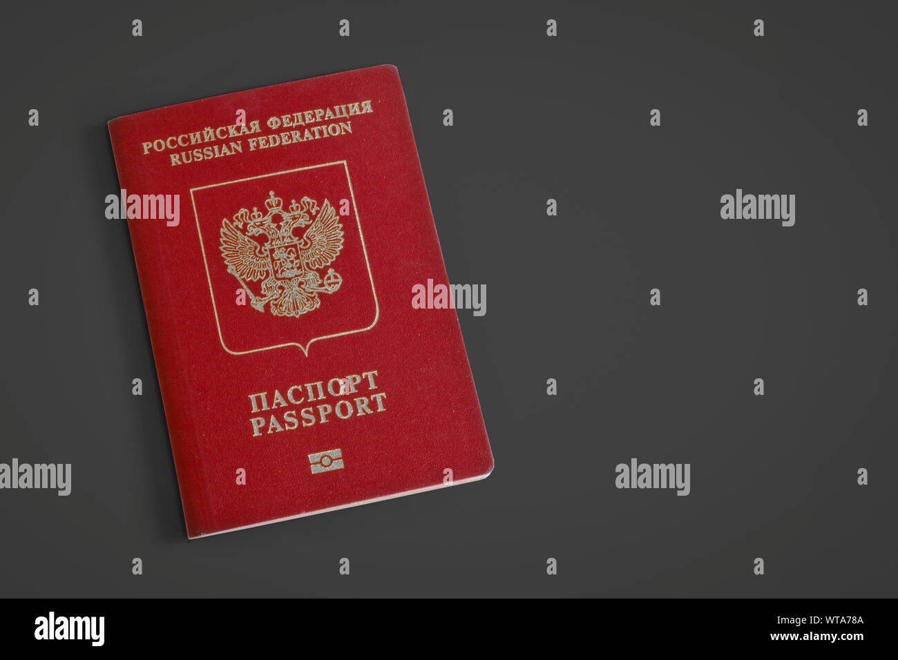 Russian foreign passport on a dark gray background. Dark red passport