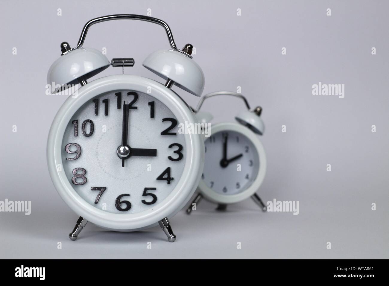 Clock marking winter time change in autumn white background Stock Photo