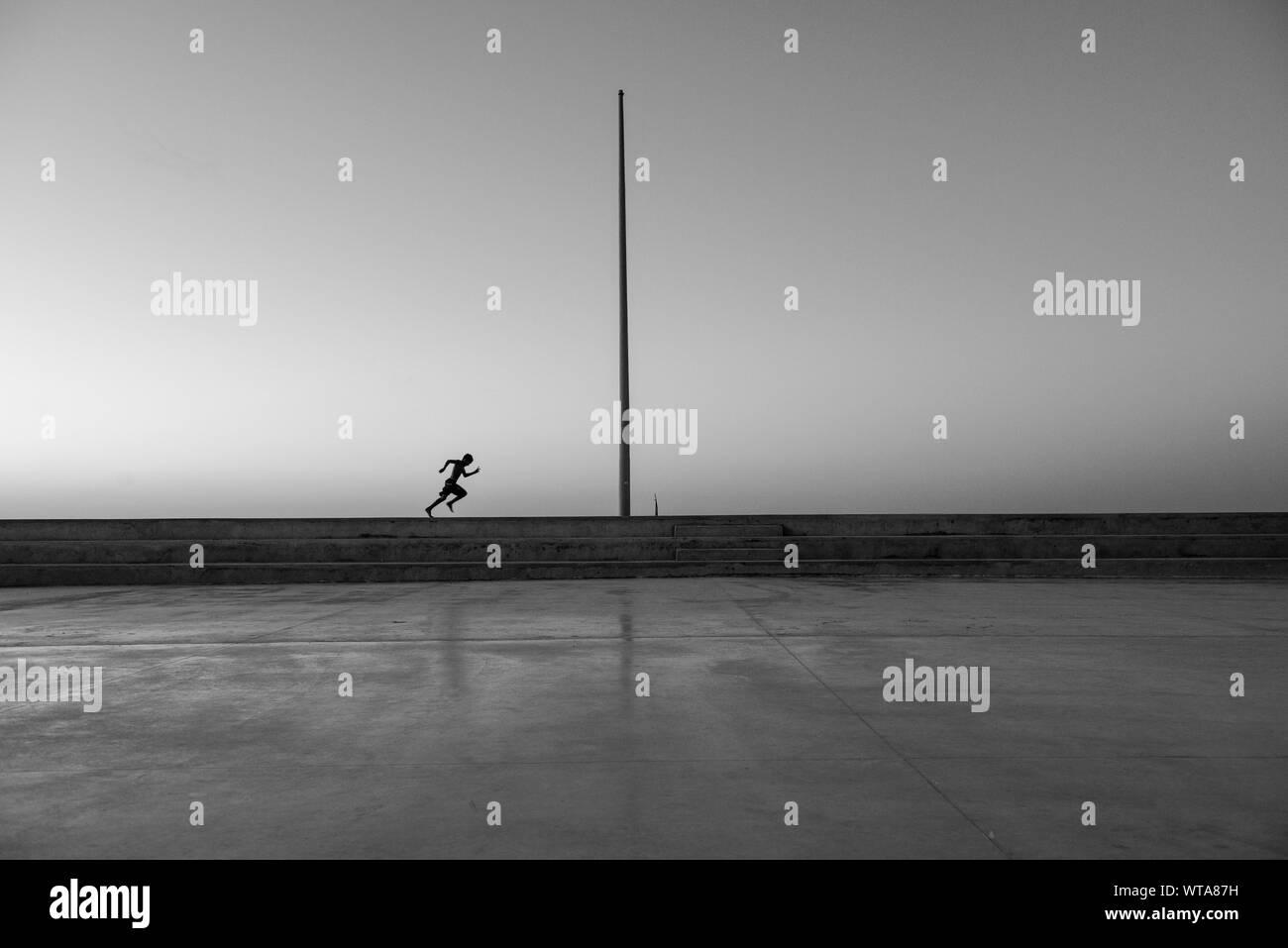 Kid running in the outdoor soccer court Stock Photo