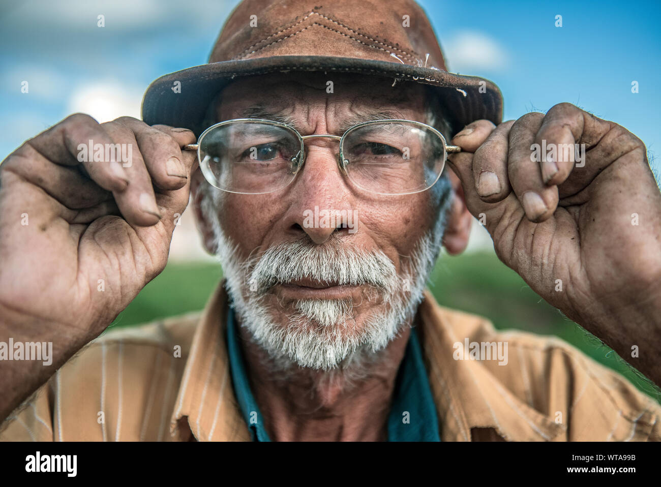 Northeastern Brazilian cowboy straighten his glasses Stock Photo