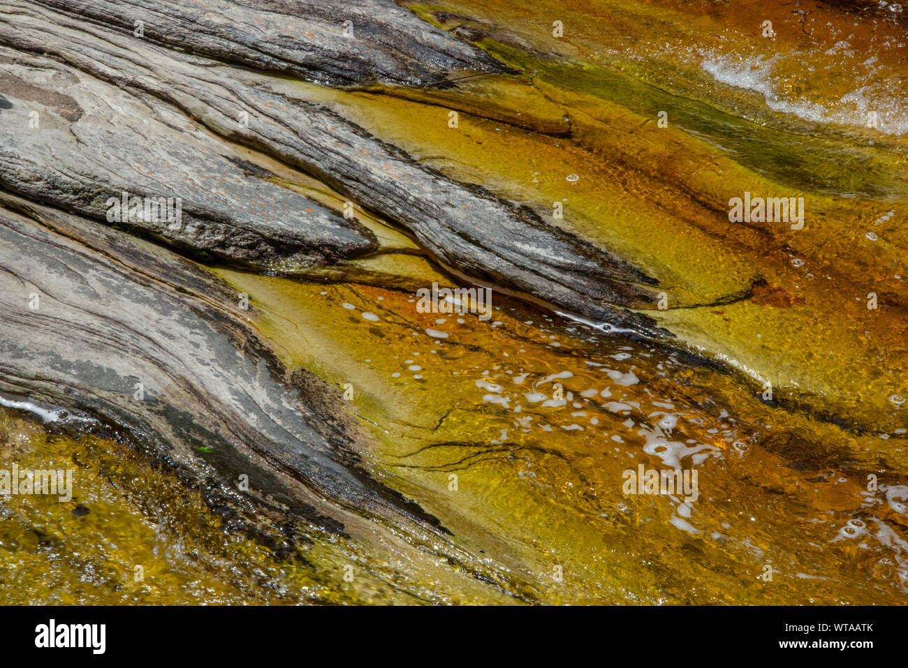 Abstract formation of rocks and water on river Stock Photo