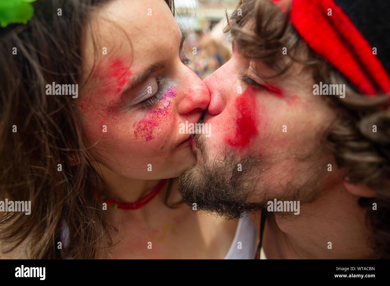 Young couple passionately kissing at the carnival Stock Photo