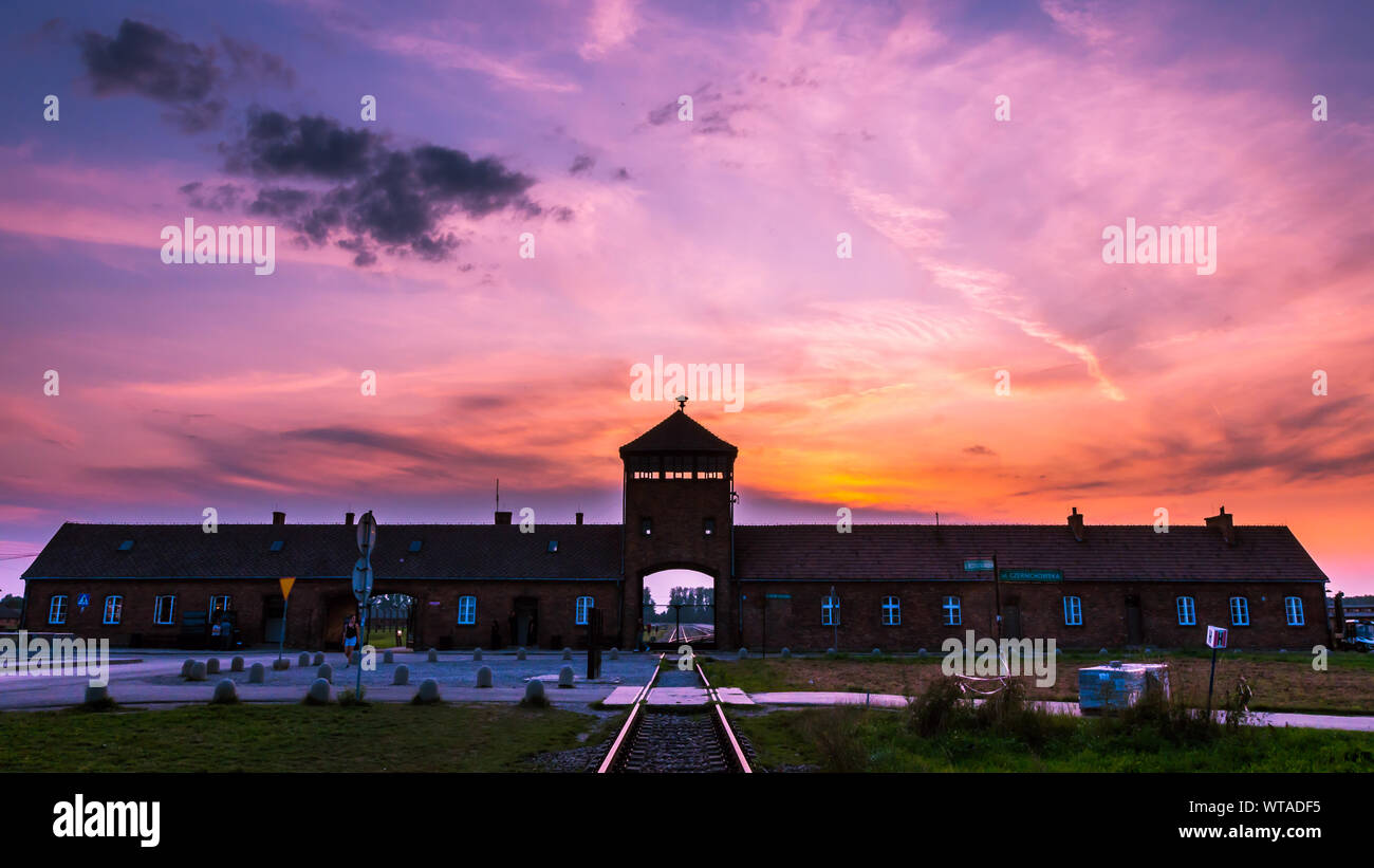 AUSCHWITZ BIRKENAU, POLAND - September 1, 2019: Main entrance to the concentration camp at sunset Stock Photo