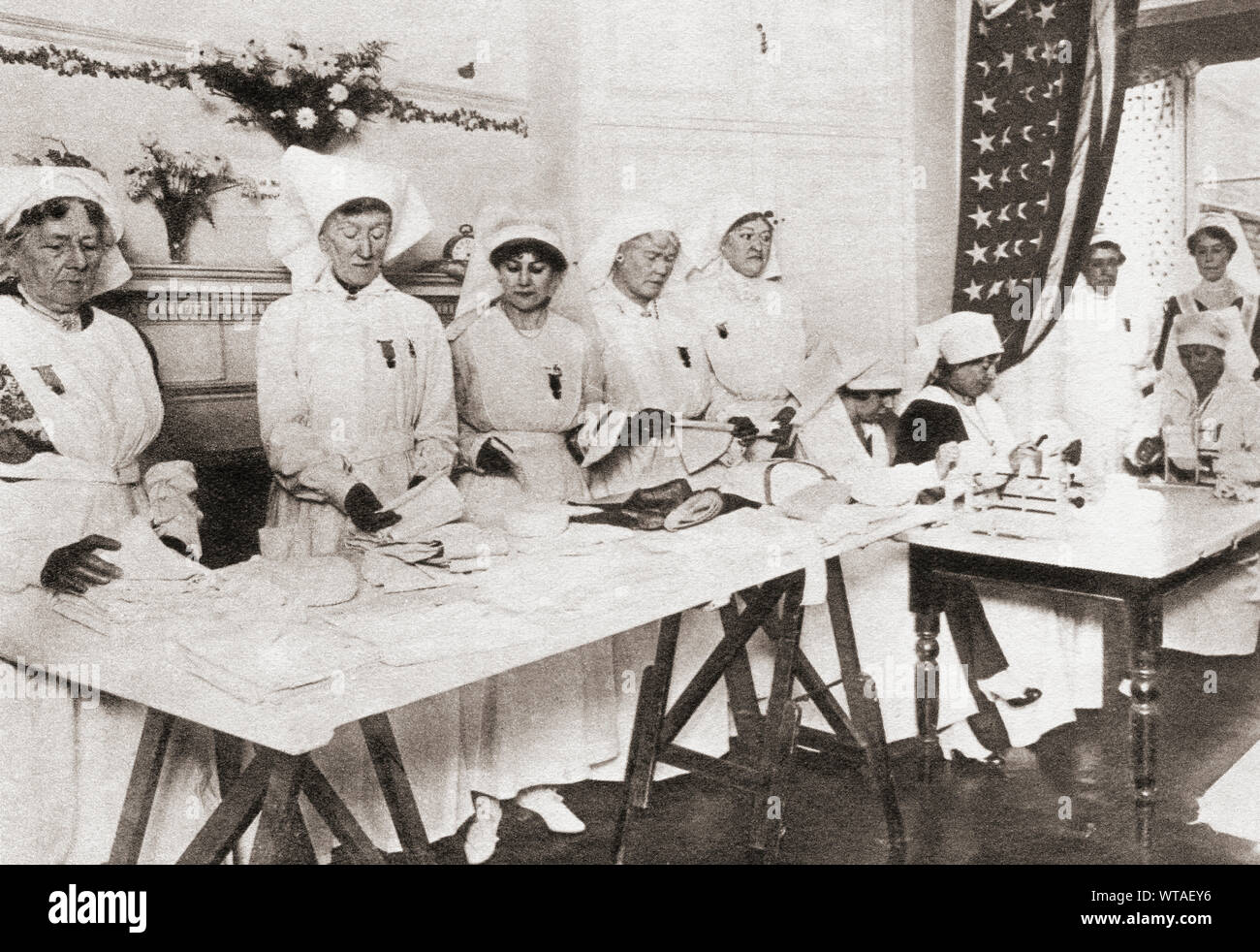Rooms in Mayfair mansions turned into workrooms for the manufacture of hospital requisites during WWI. Seen here women volunteers.  From The Pageant of the Century, published 1934. Stock Photo