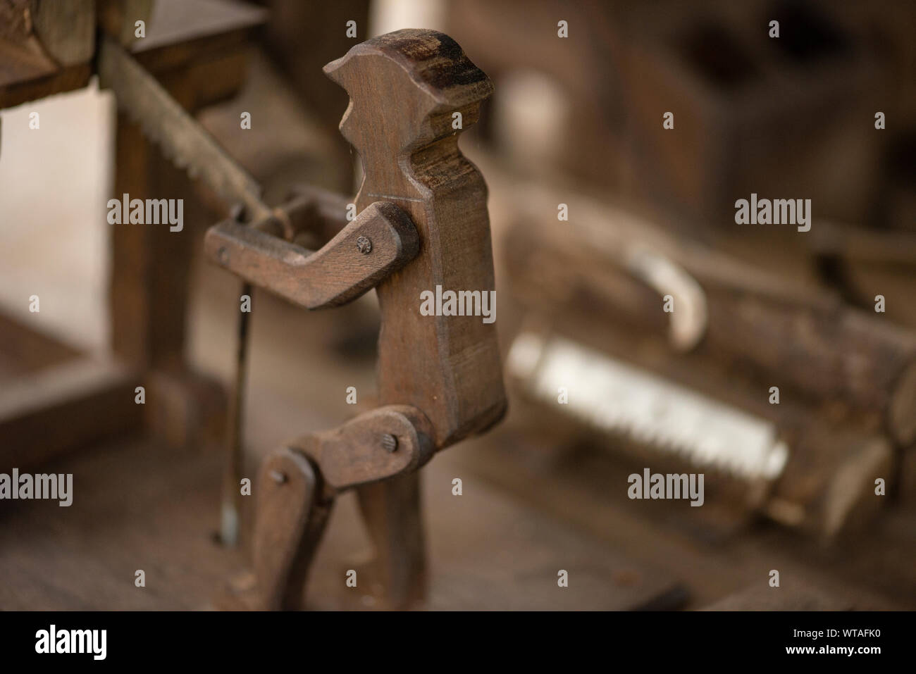 Wood sculpture of man working in a sawmill Stock Photo