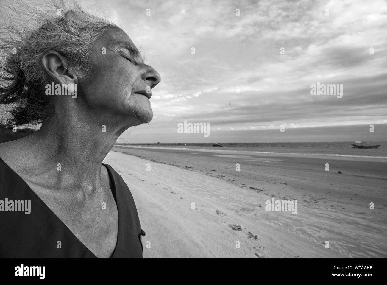 Native old lady of fishing community thoughtful in the wind Stock Photo