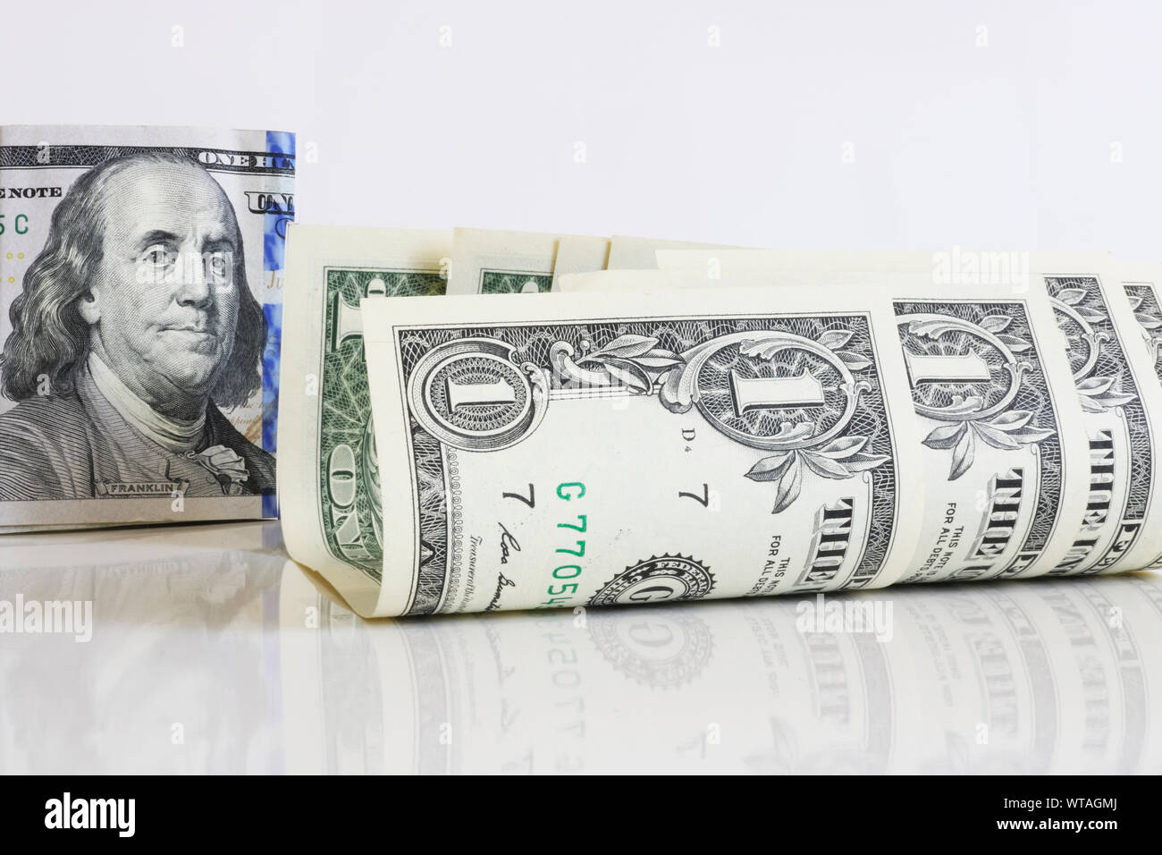 Slightly curled one-dollar bills on a light background close-up. In the ...