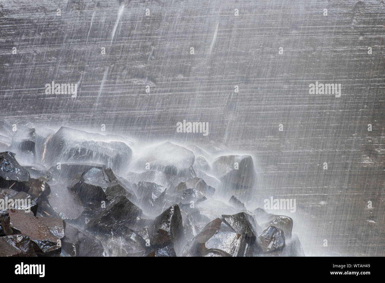 The Snow Waterfall waters falling in high volume on rocks Stock Photo