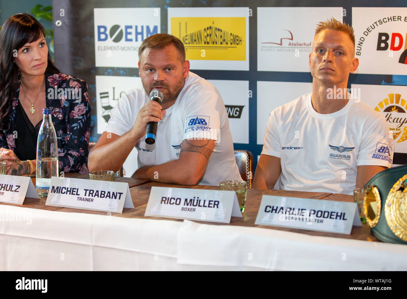 Berlin, Germany. 11th Sep, 2019. Boxing: Superlightweight, World Championship, press conference before the IBO World Championship: Müller (Germany) - Ponce (Argentina) in the Loretta at the Spree. Organizer Steffi Schulz (l-r), trainer Michel Trabant and boxer Rico Müller are at the press conference. Credit: Andreas Gora/dpa/Alamy Live News Stock Photo