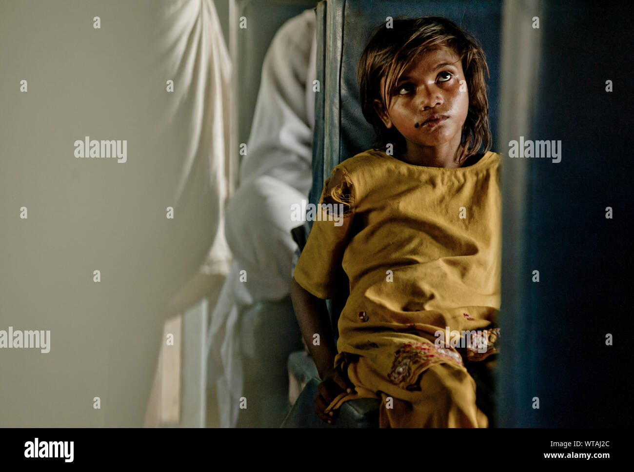 Poor girl travelling in a train in Kashmir Stock Photo