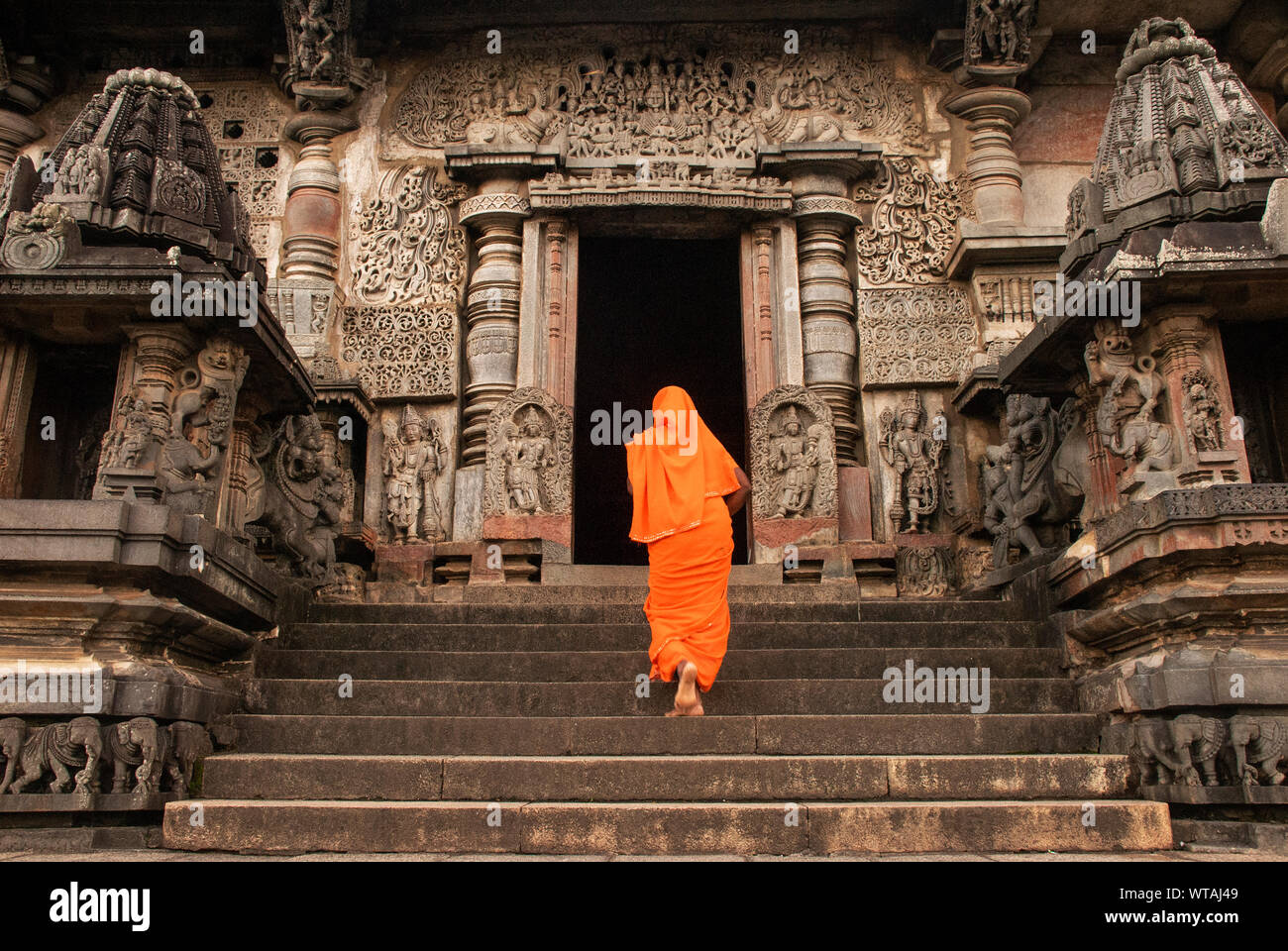 Indian woman worshiping at Hoysaleswara Temple Stock Photo