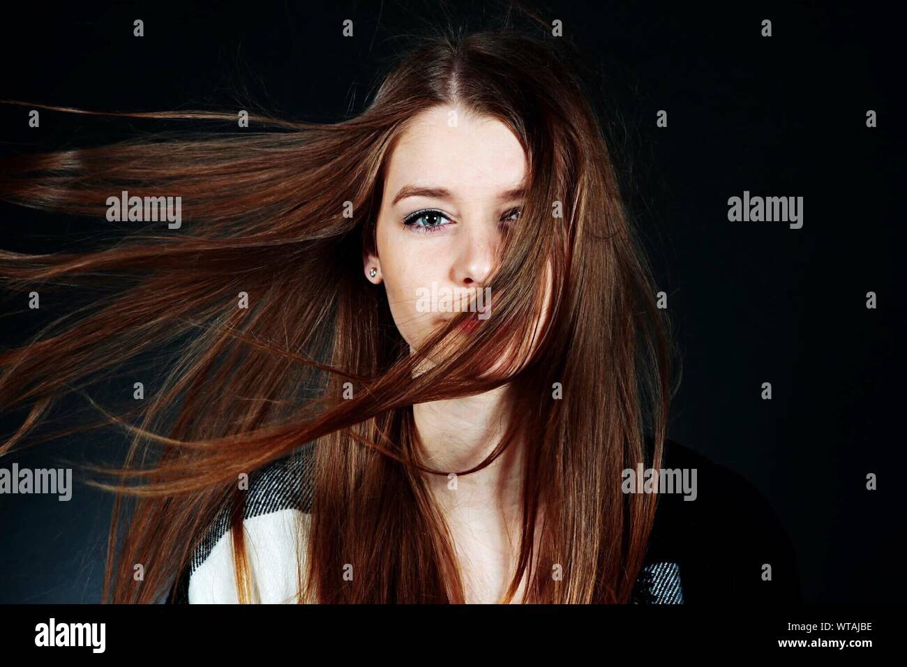 Portrait Of Young Woman With Hair In Face Stock Photo