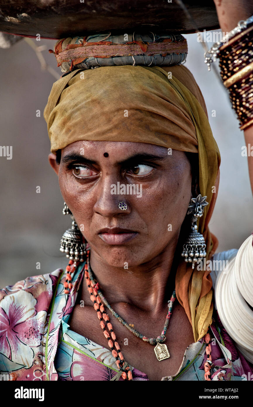 Rajasthani woman carrying water in the head Stock Photo