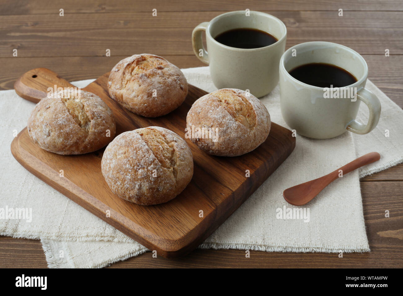 french rye bread with cups of coffee isolated on wooden table Stock Photo