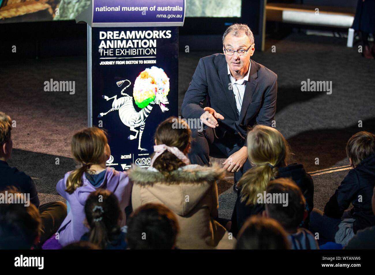 (190911) -- CANBERRA, Sept. 11, 2019 (Xinhua) -- Director of the National Museum of Australia (NWA) Mathew Trinca talks with students from local schools at NWA in Canberra, Australia, Sept. 11, 2019. NMA will launch the DreamWorks Animation: The Exhibition on Thursday. Running until Feb. 2, 2020, the exhibition features more than 400 items from 33 DreamWorks Animation films, including Shrek, Madagascar, Kung Fu Panda, Prince of Egypt, How to Train Your Dragon. TO GO WITH 'Feature: Walking into the world of Shrek and Kung Fu Panda' (Xinhua/Liang Tianzhou) Stock Photo
