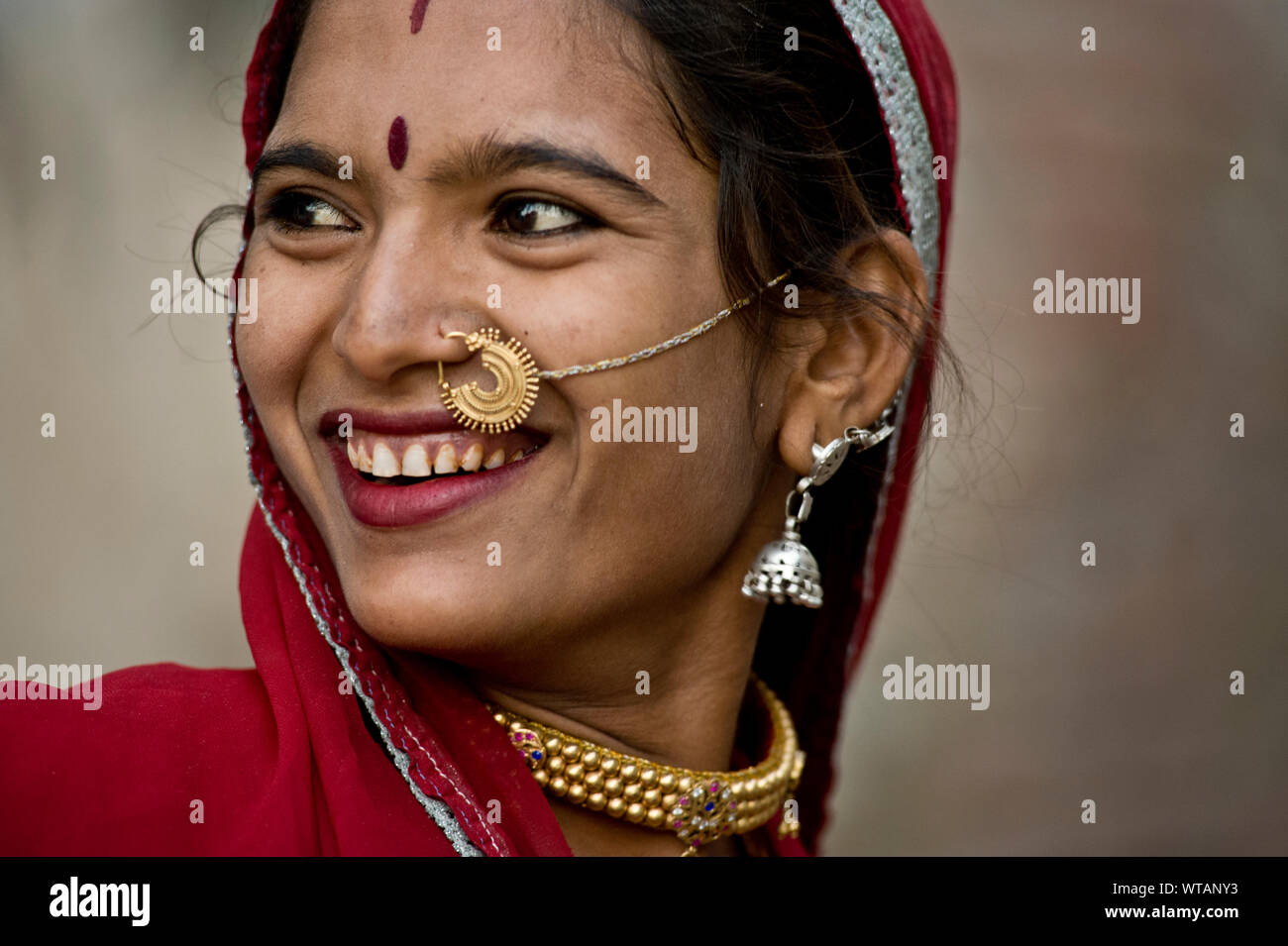 Beautiful Rajasthani woman wearing sari and traditional jewelry Stock Photo