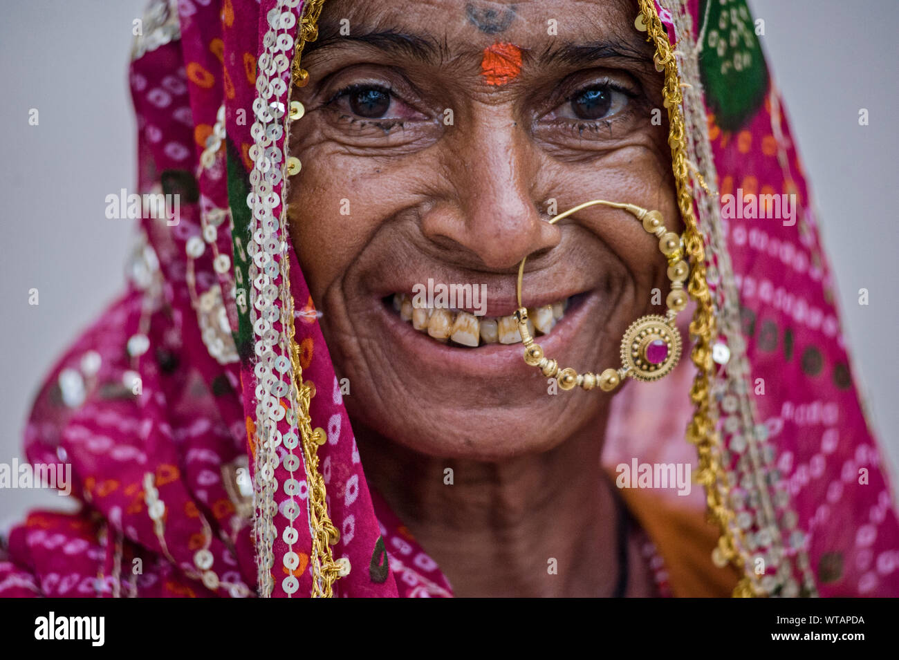 Old Rajasthani woman with huge nose ring and dirty teeth Stock Photo