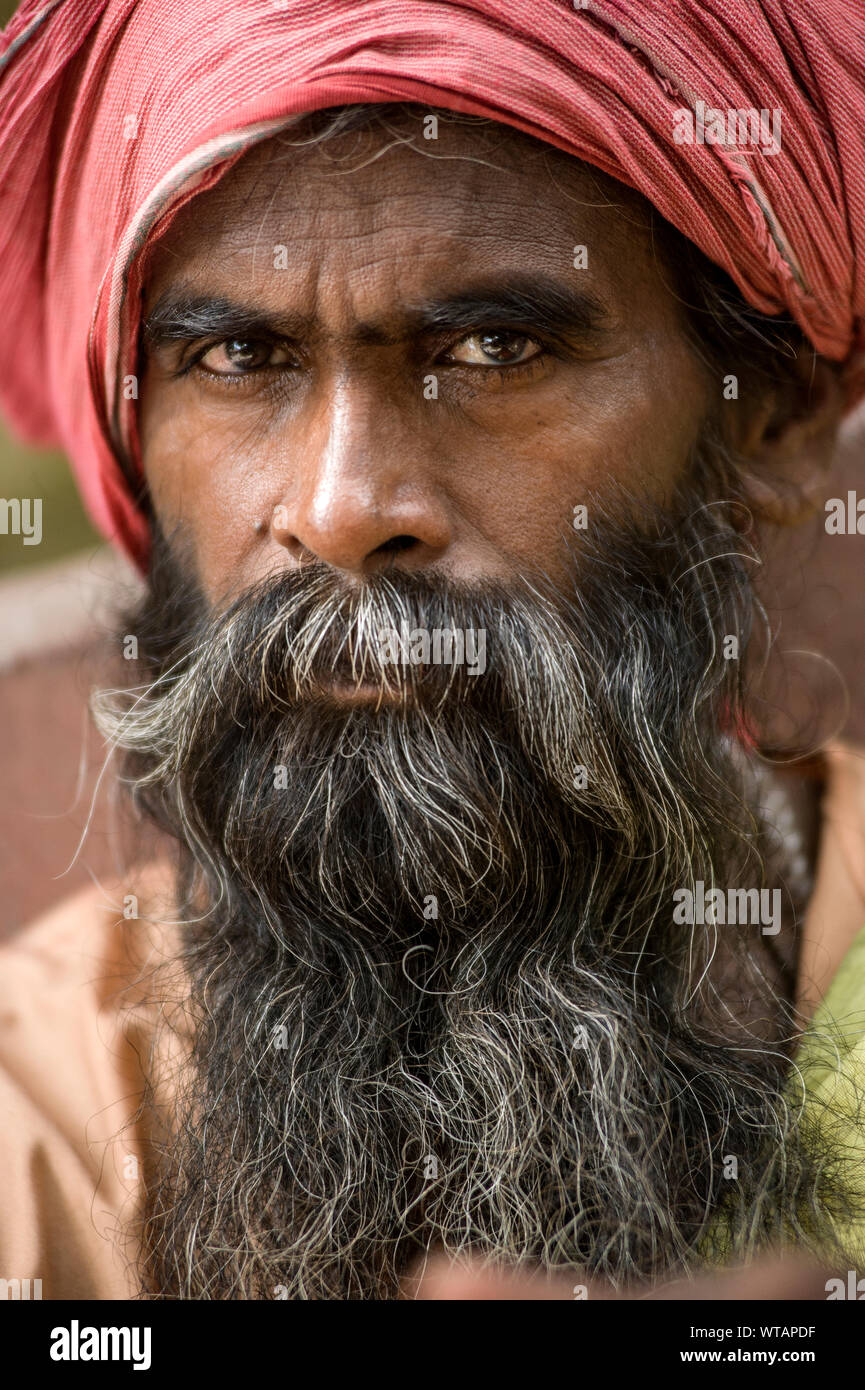 Religious man with long beard and red turban Stock Photo