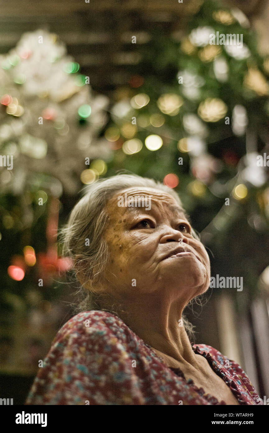 Old woman in the streets of Bangkok Stock Photo